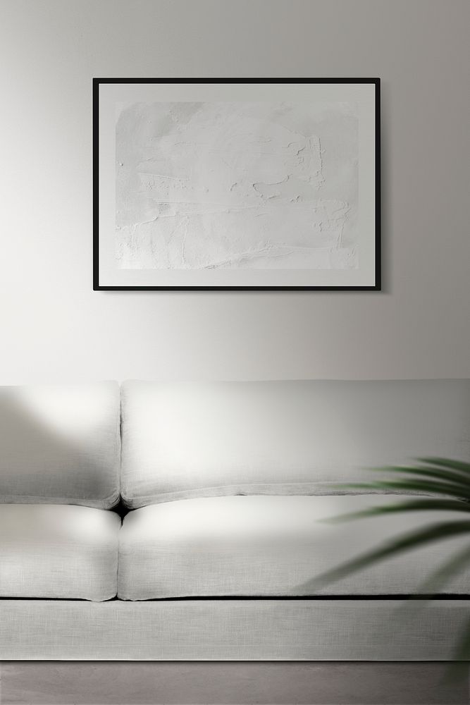 Picture frame mockup psd hanging in minimal living room home decor interior