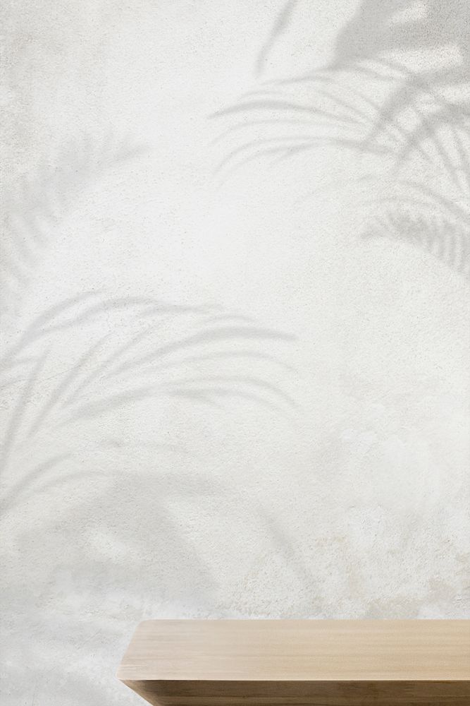 Product backdrop, empty wooden table with concrete wall and plant shadow