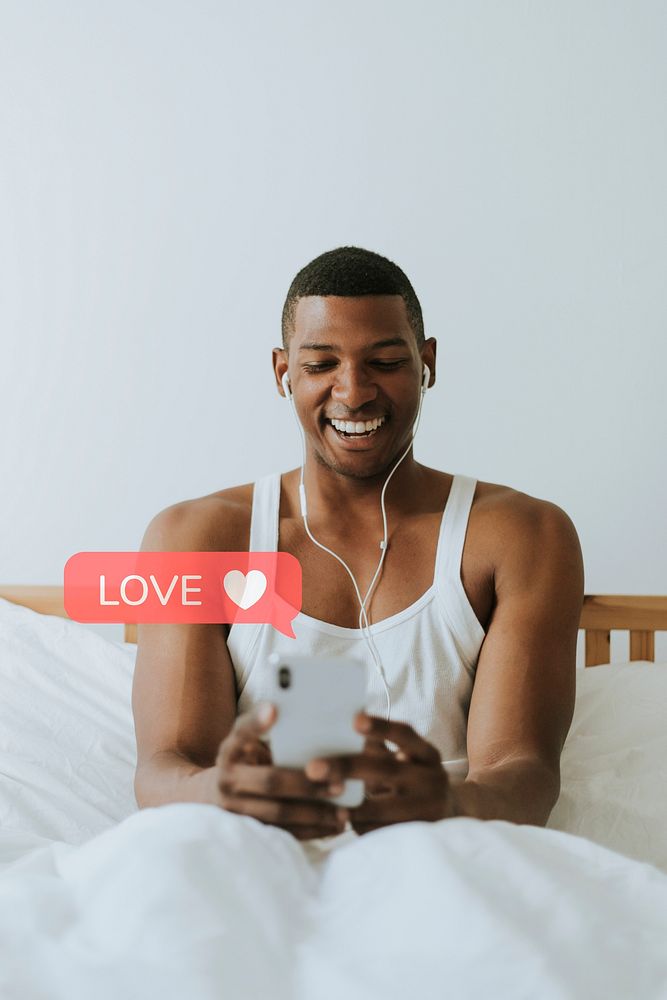 Cheerful black man texting on his phone
