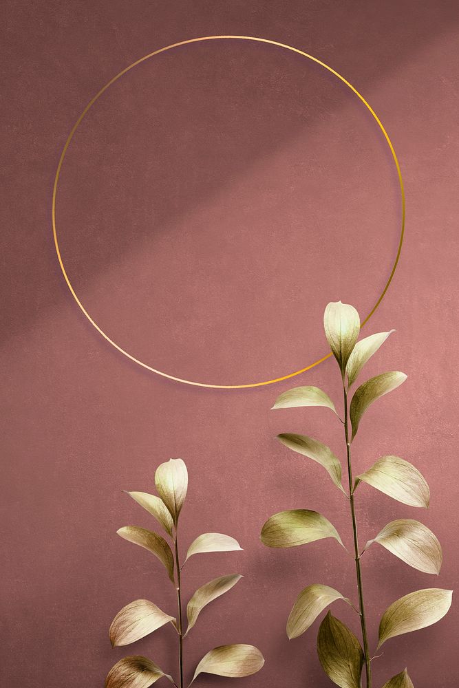 Round golden nature frame on a pink background