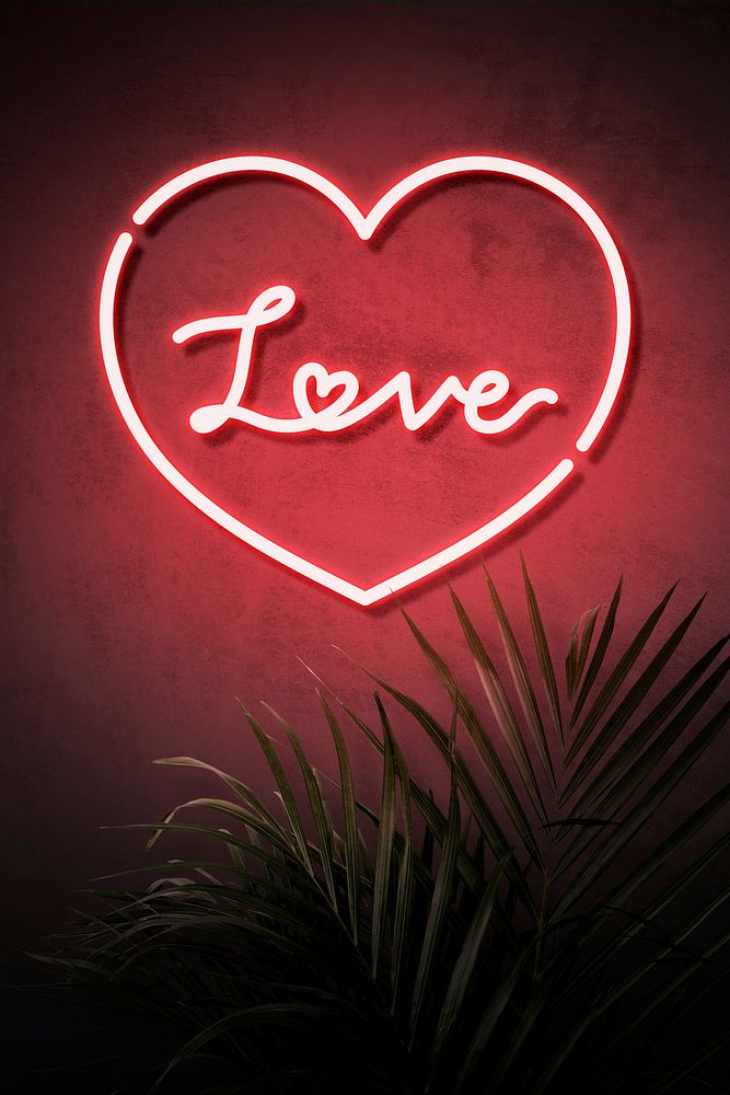 Neon red heart frame with love on a wall