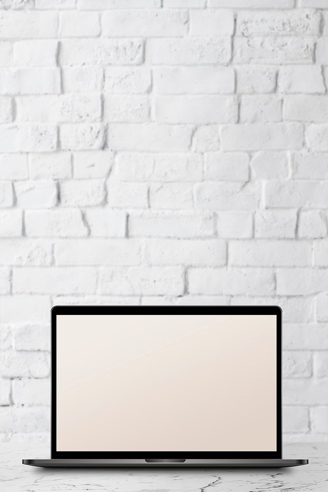 Laptop with screen mockup on a white marble table