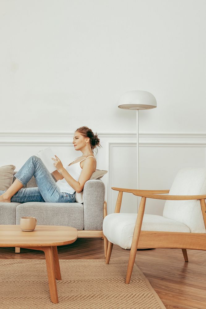 Woman reading a book in a minimal home