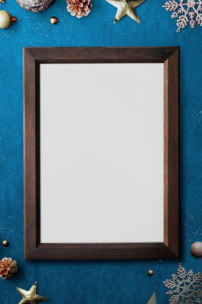 Wooden frame mockup with Christmas decorations on blue background