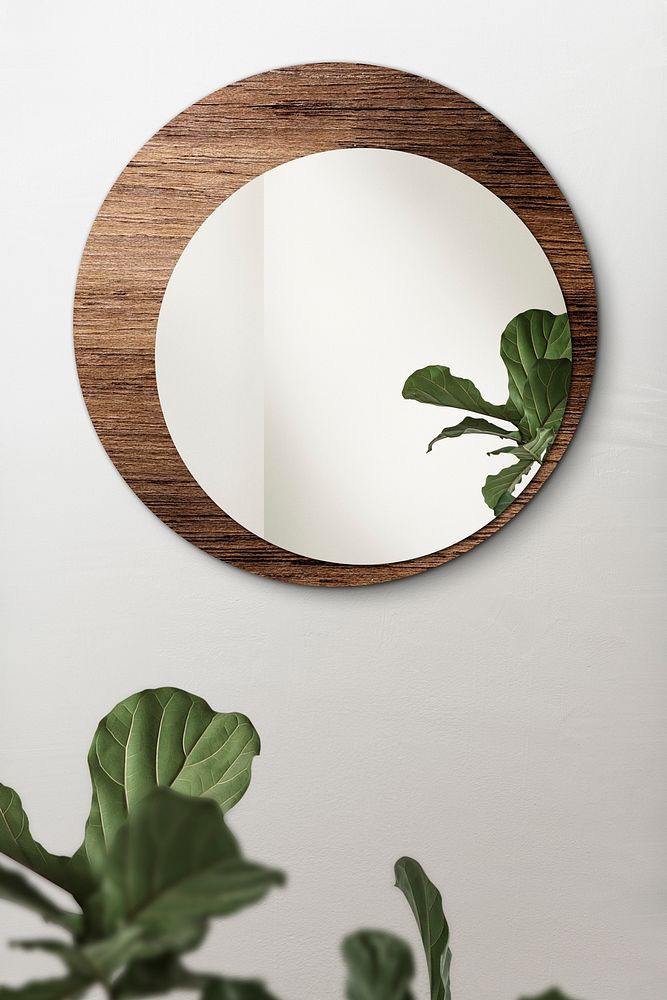 Circular mirror with a wooden backdrop mirroring fiddle-leaf fig mockup