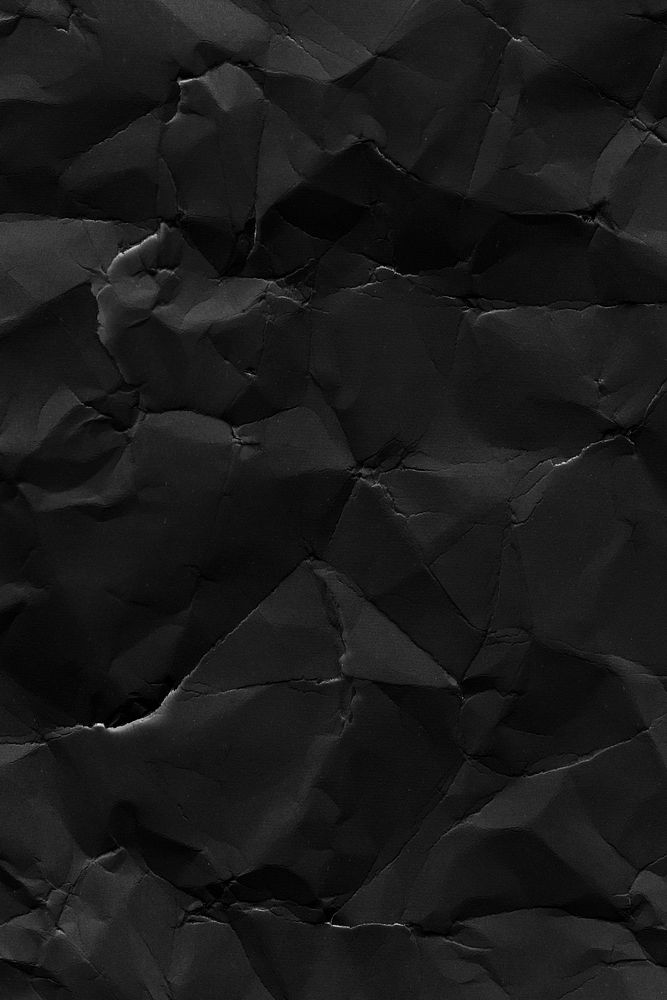 Crumpled black paper textured background