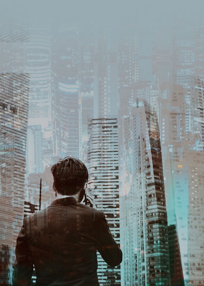 Young businessman on phone city background