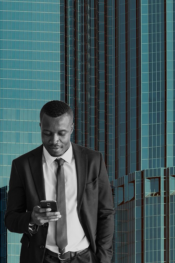 Black businessman on phone over city background