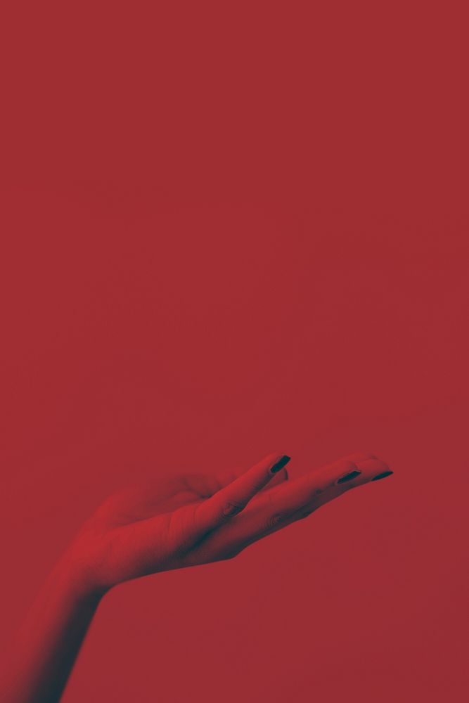 Woman hand on red background