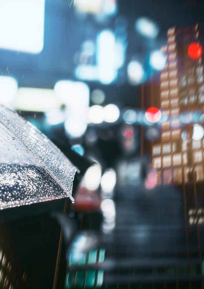 Businessman with umbrella in rainy city