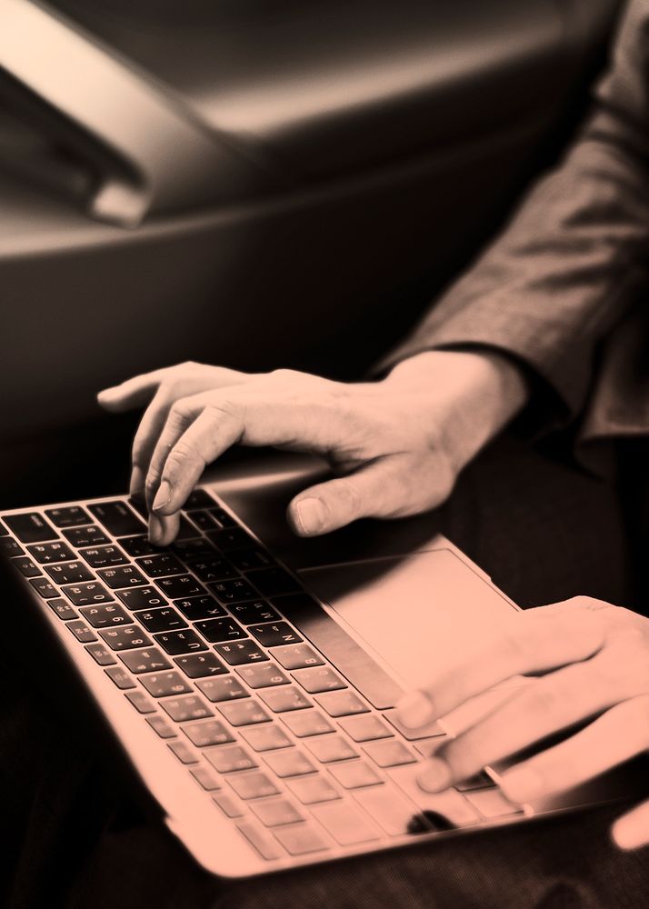 Businesswoman using laptop in car monochrome