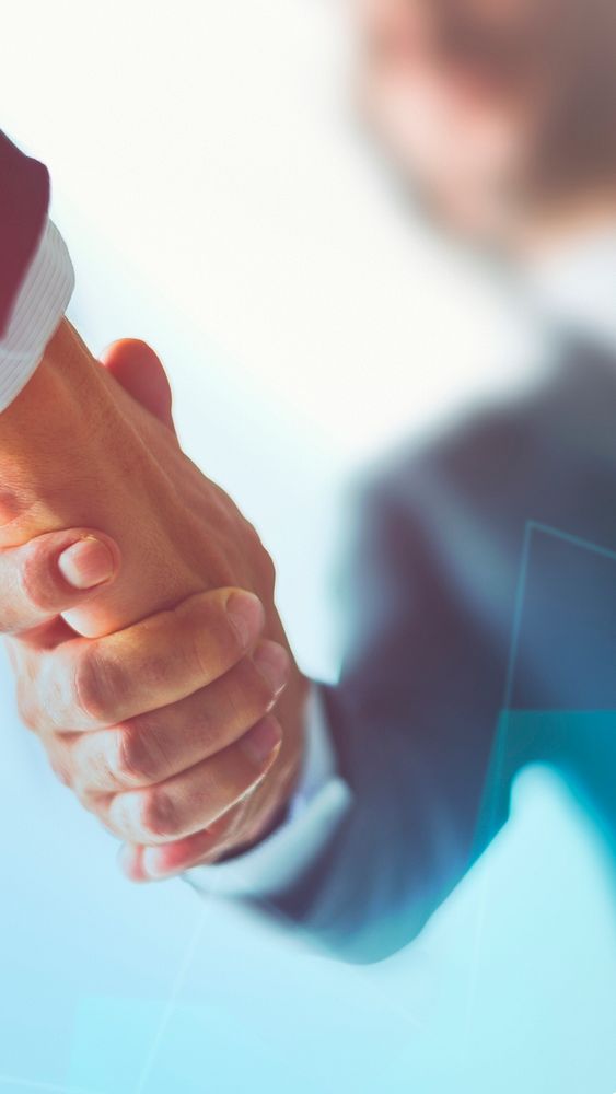 Business people shaking hands in agreement background