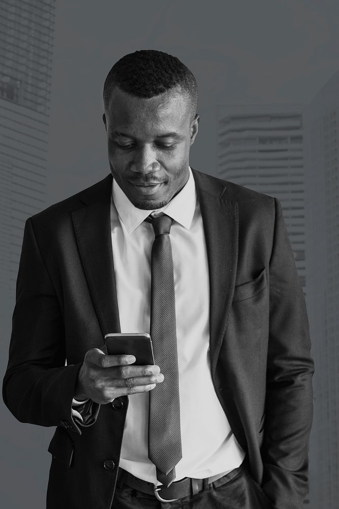Businessman working using smartphone monochrome