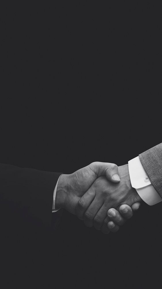 Business partners shaking hands monochrome