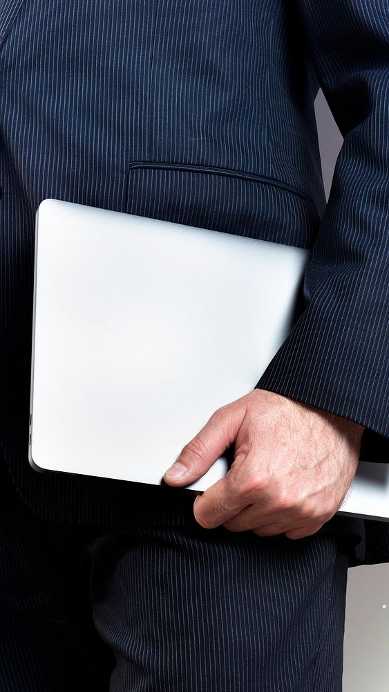 Successful businessman holding a laptop