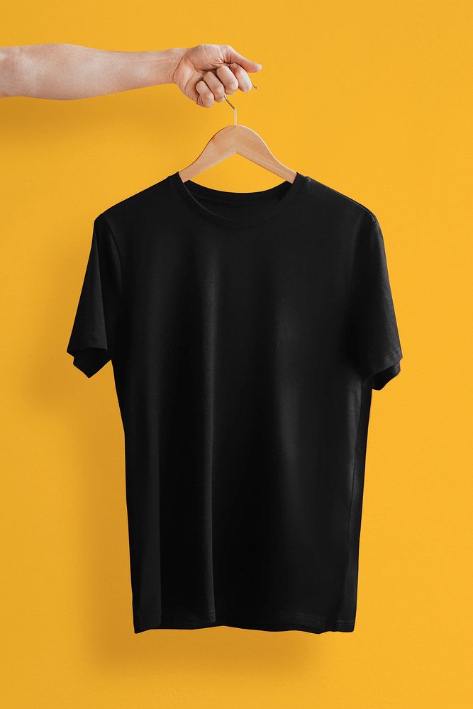 Simple t-shirt in black with hand holding hanger with design space