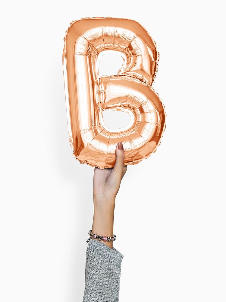 Hand holding capital letter B balloon