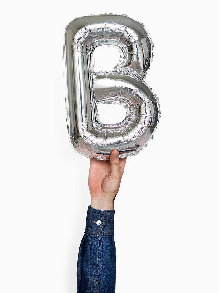 Hand holding capital letter B balloon