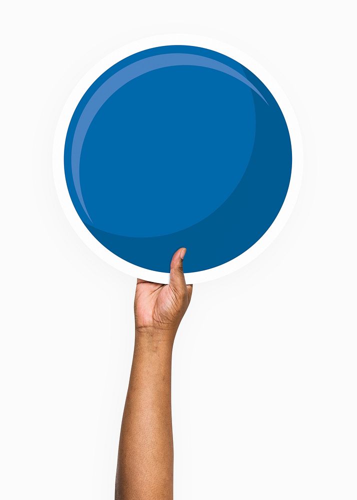Hand holding a round blue cardboard prop