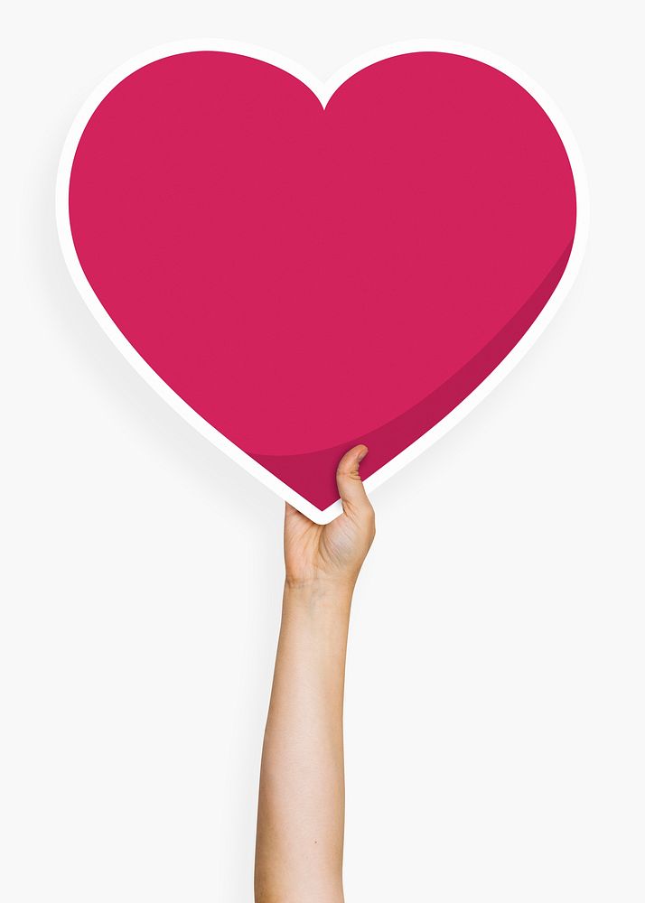 Hand holding a heart cardboard prop