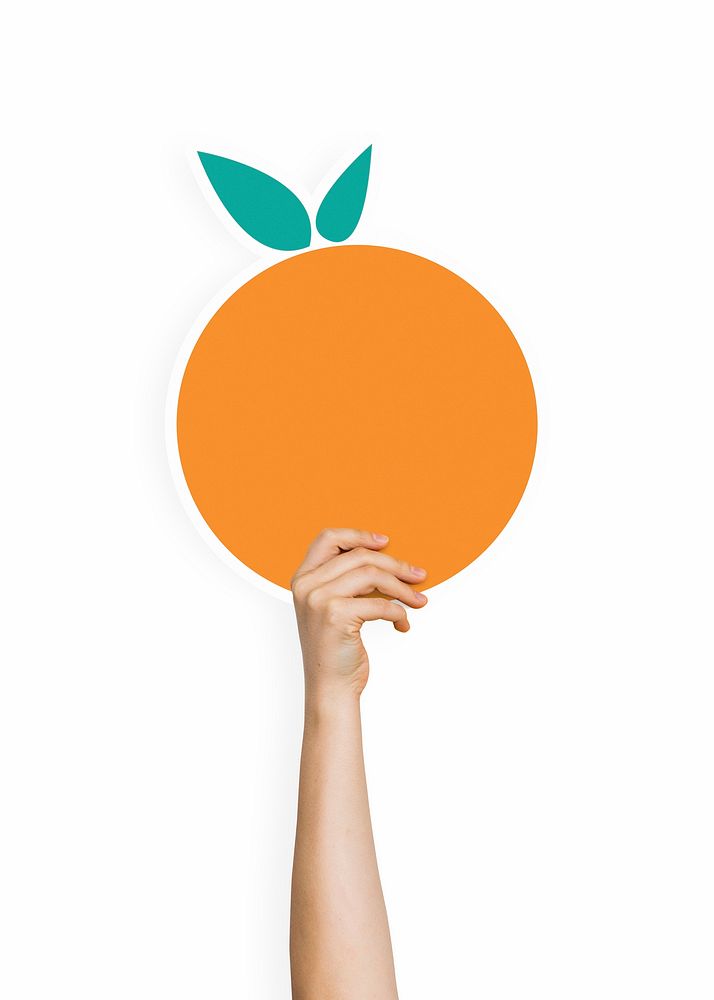 Hand holding an orange cardboard prop