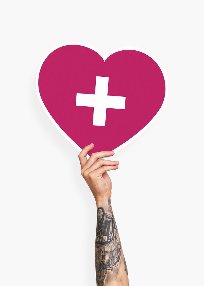 Hand holding a heart with a cross cardboard prop