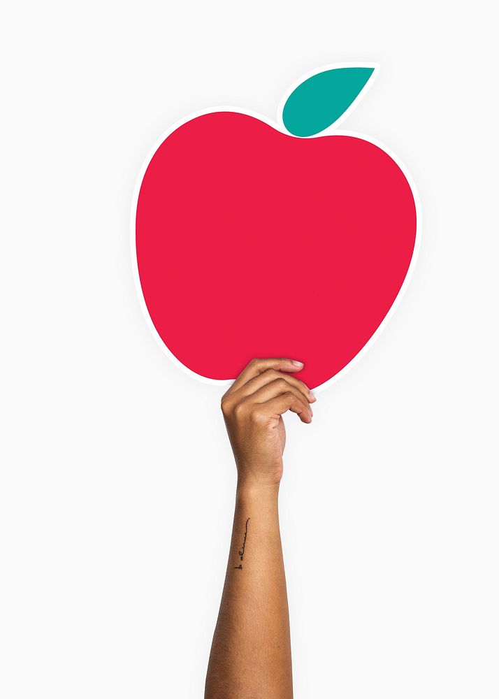 Hand holding an apple cardboard prop
