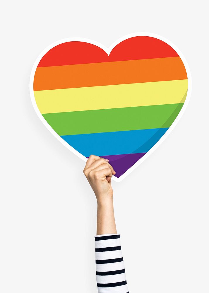 Hand holding a rainbow heart cardboard prop