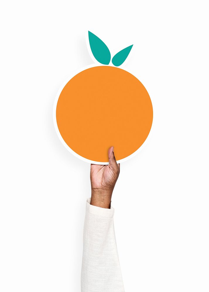 Hand holding an orange cardboard prop