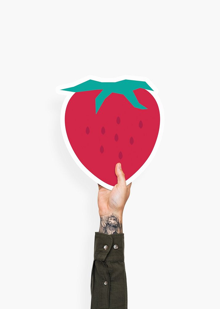 Hand holding a strawberry cardboard prop