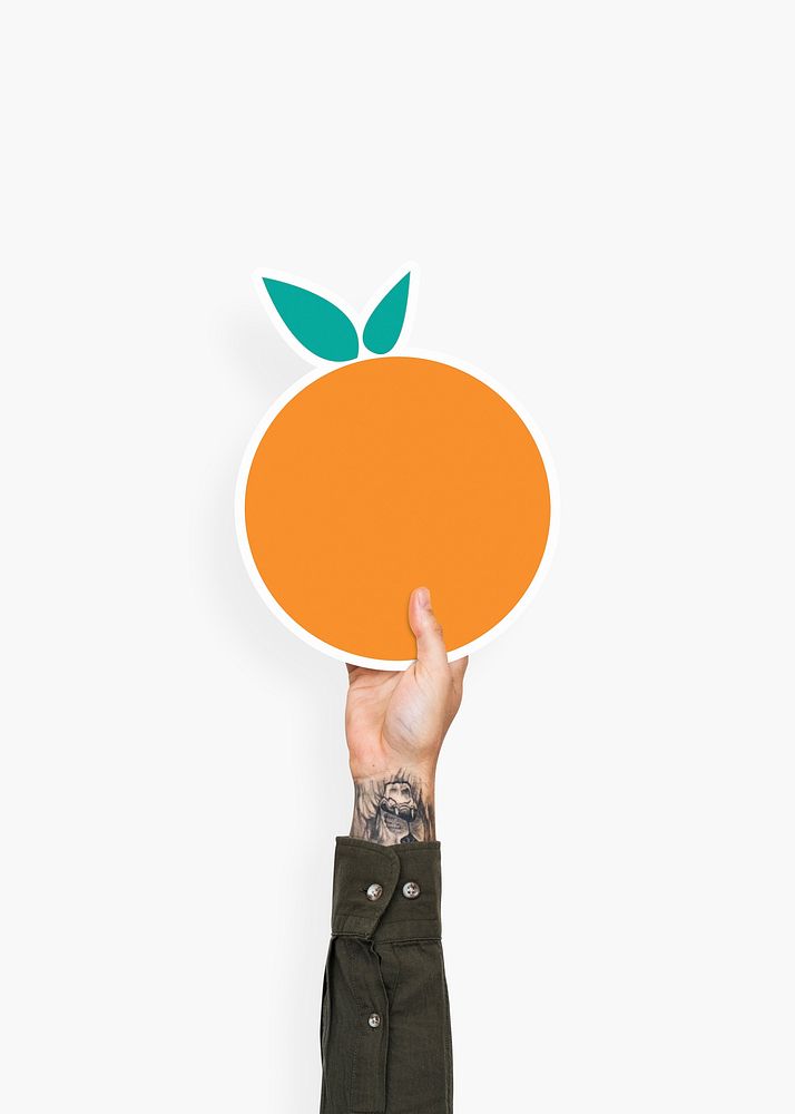 Hand holding an orange cardboard prop