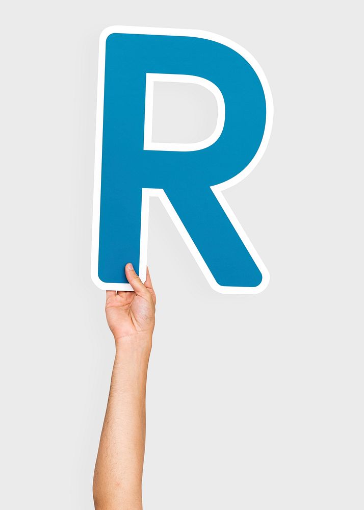 Hand holding the letter R