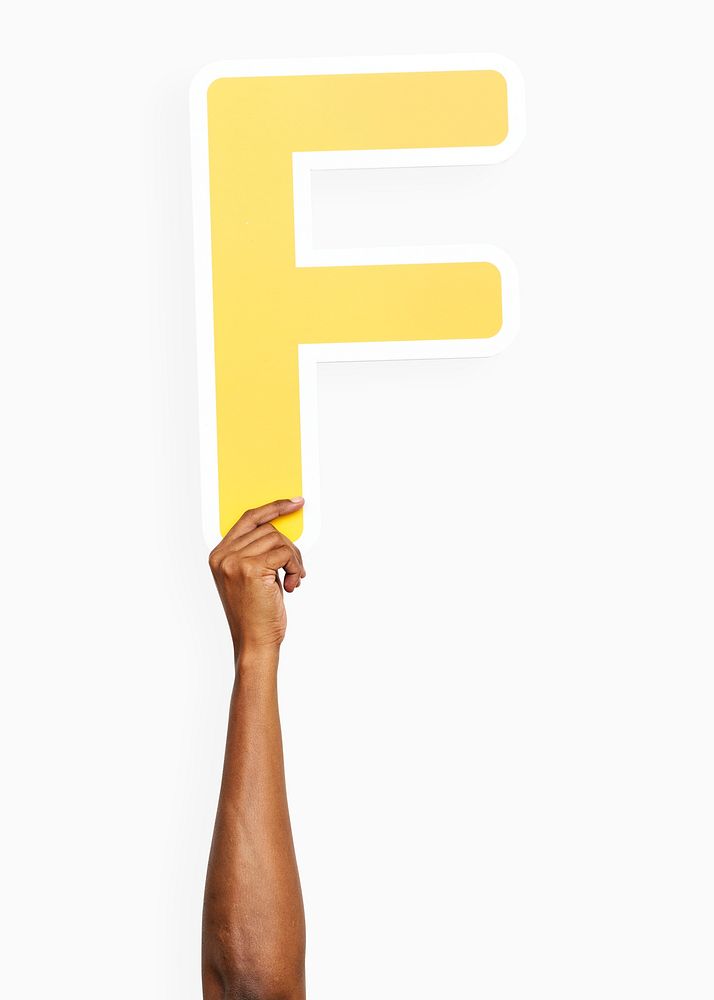 Hand holding the letter F
