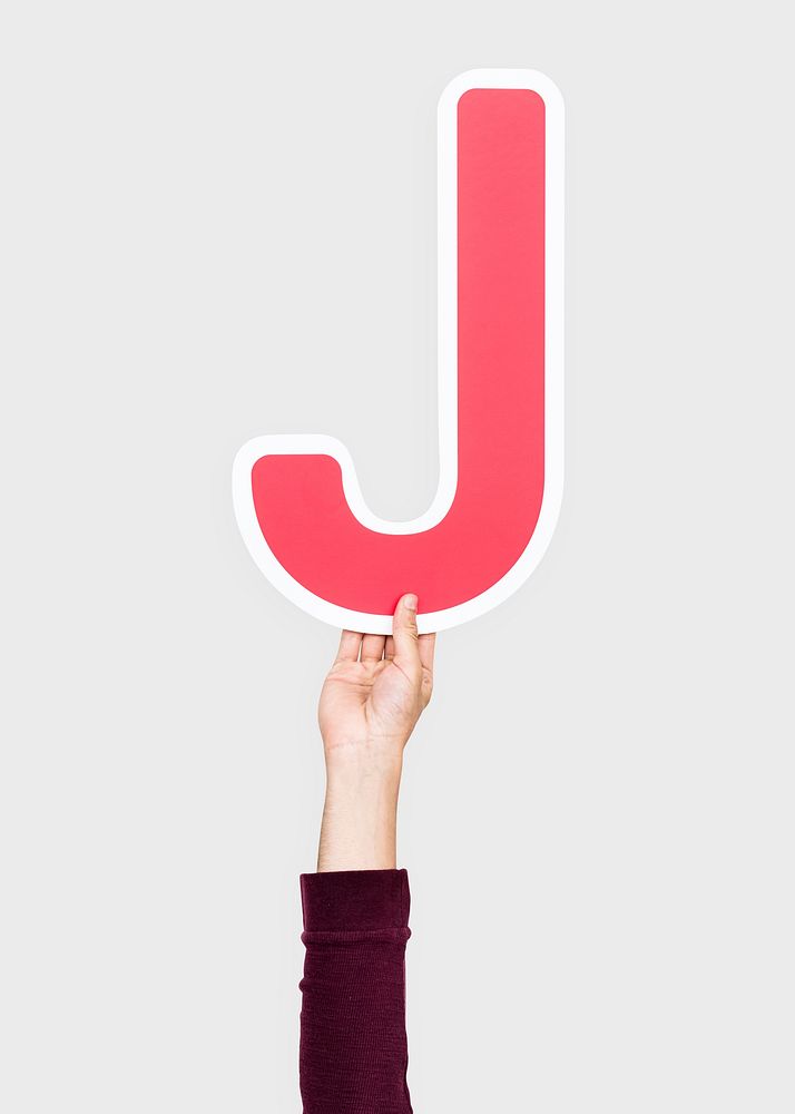 Hand holding the letter J