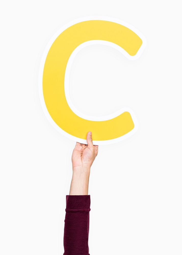 Hand holding the letter C
