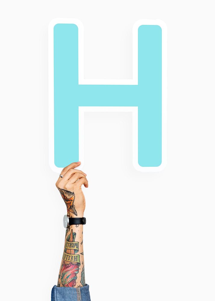 Tattooed hand holding H sign, isolated on white