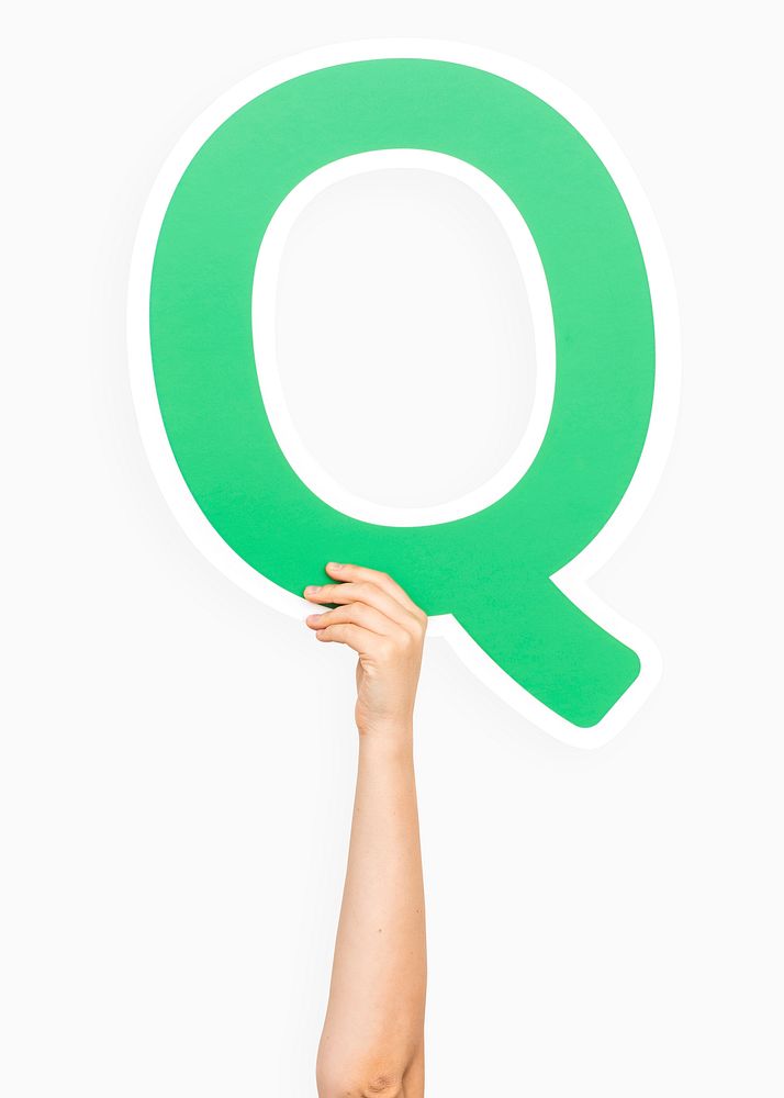 Hand holding the letter Q