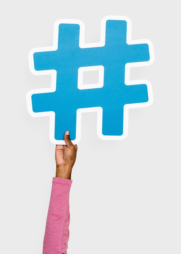 Hand raised holding hashtag icon
