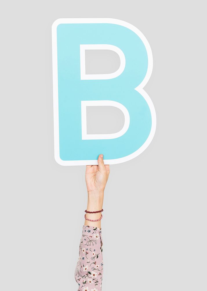 Hand holding the letter B