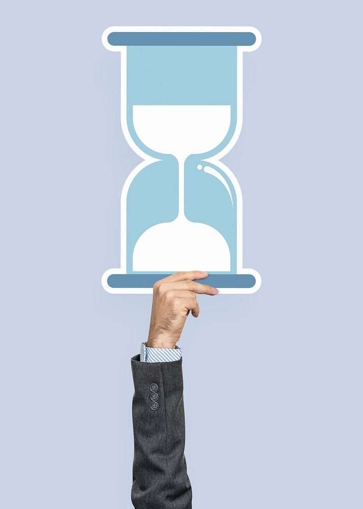Hand holding an hourglass clipart