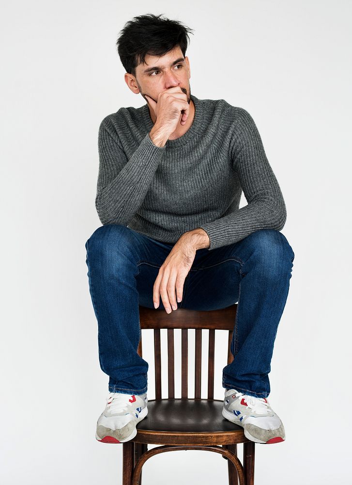 Portrait of a man thinking while sitting on a chair