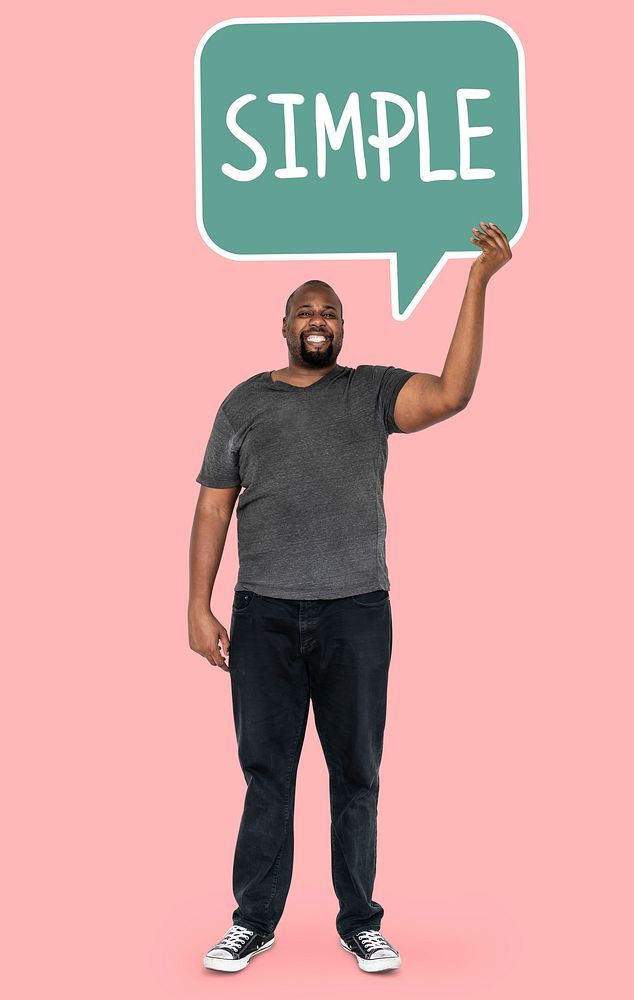 Cheerful man showing word simple in a speech bubble
