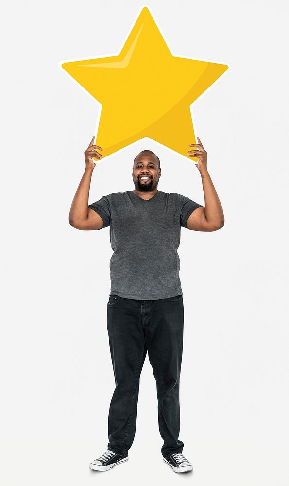 Cheerful man holding a golden star rating symbol