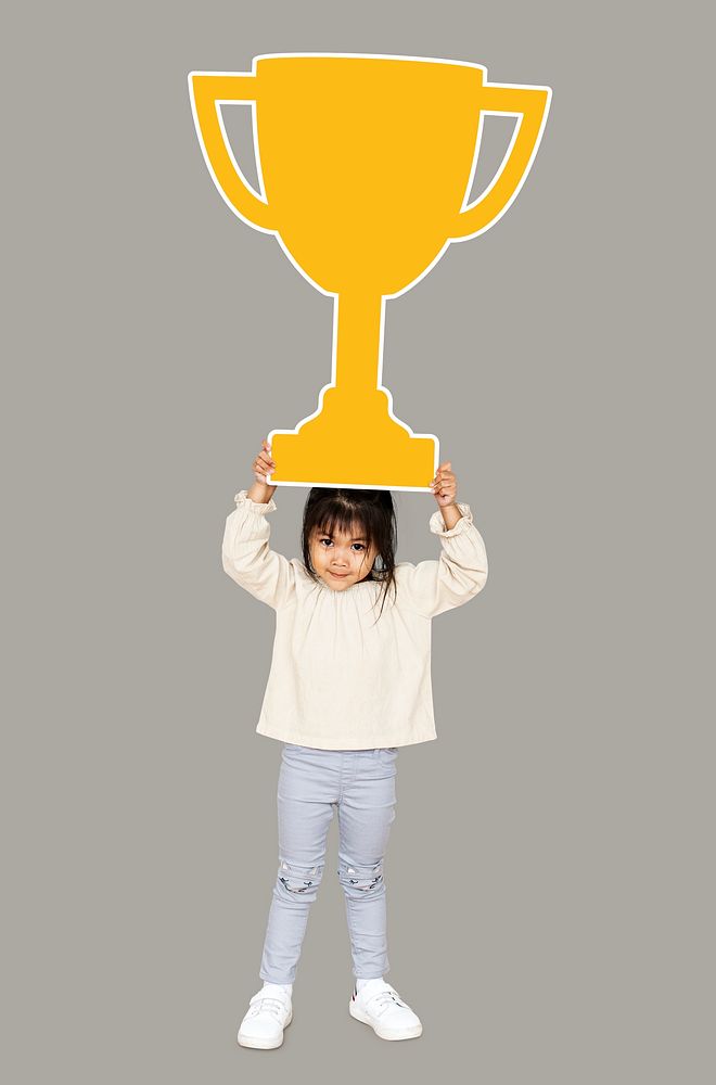 Girl celebrating success with a trophy