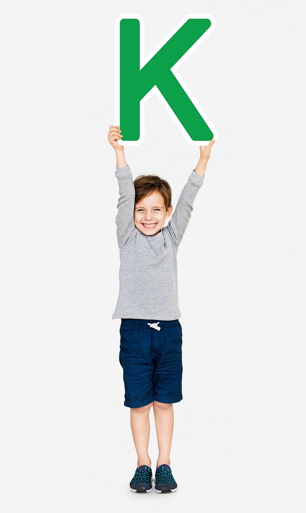 Happy boy holding the letter K