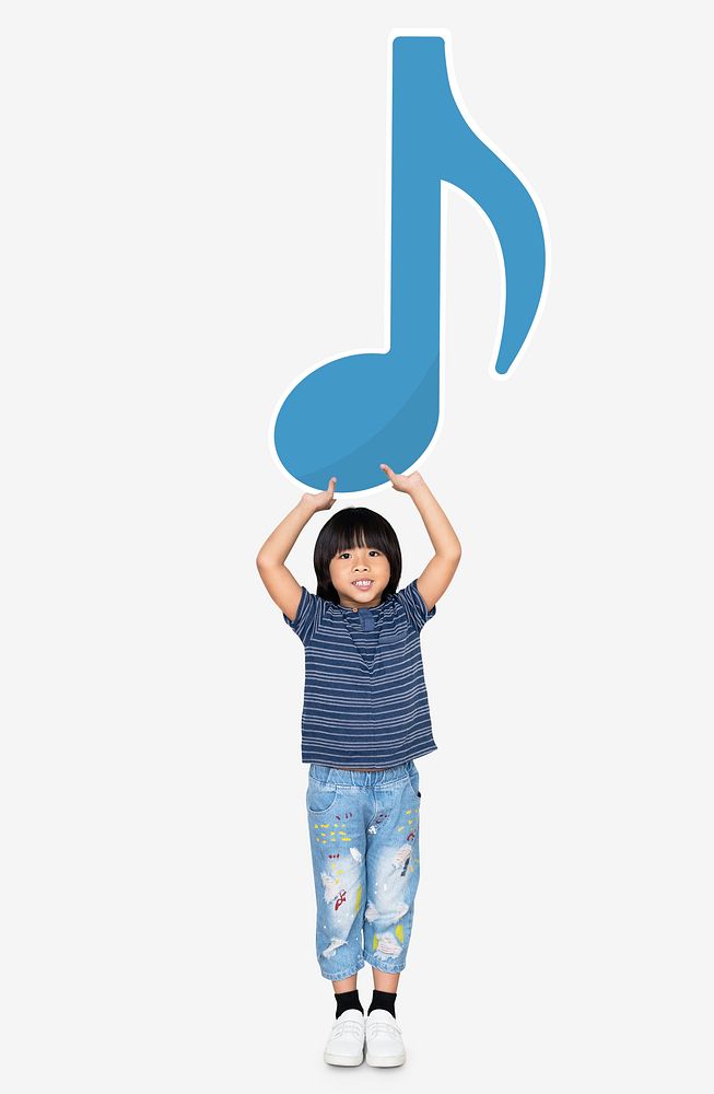 Young boy holding a music note