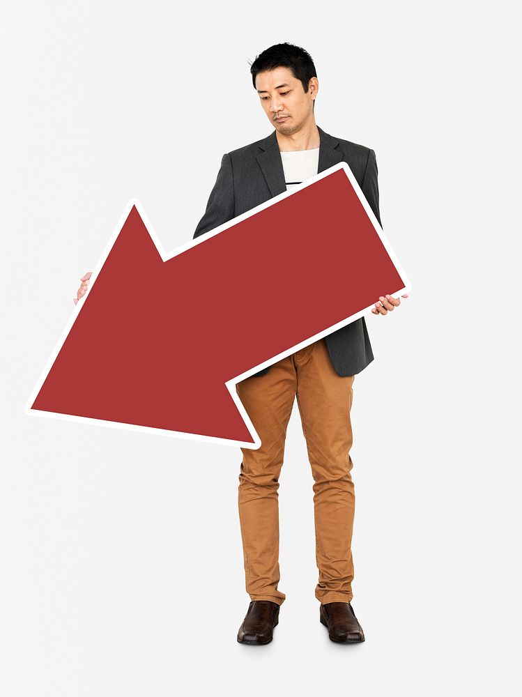 Sad businessman holding a red arrow