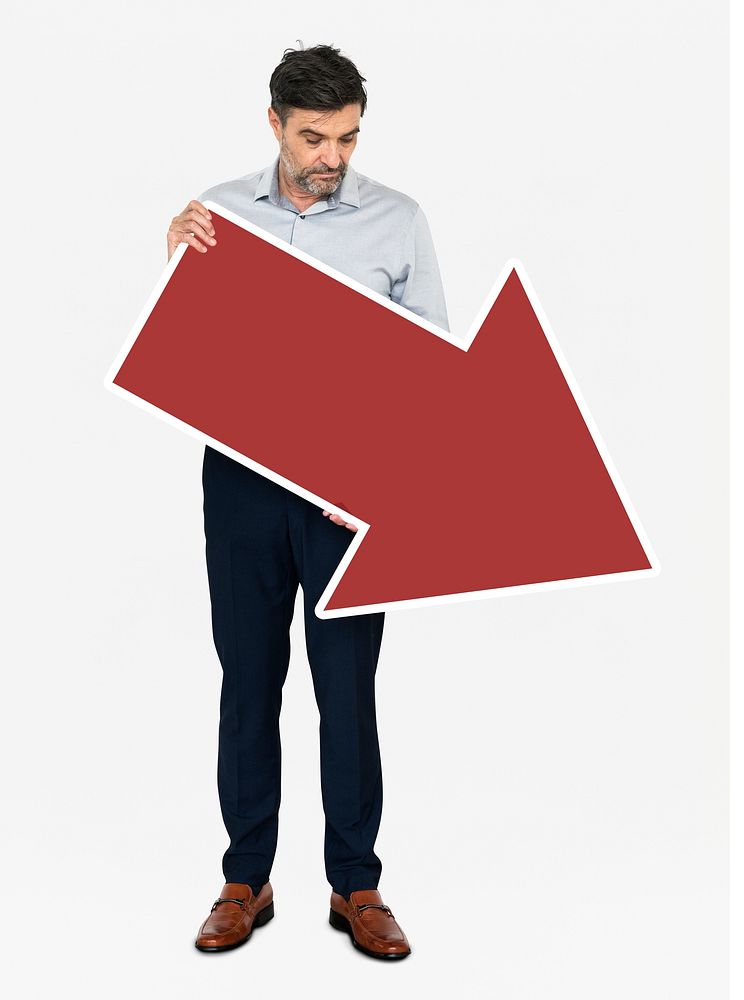 An unhappy businessman holding a red arrow
