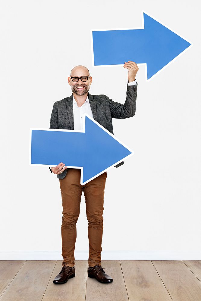 Businessman holding two blue arrows