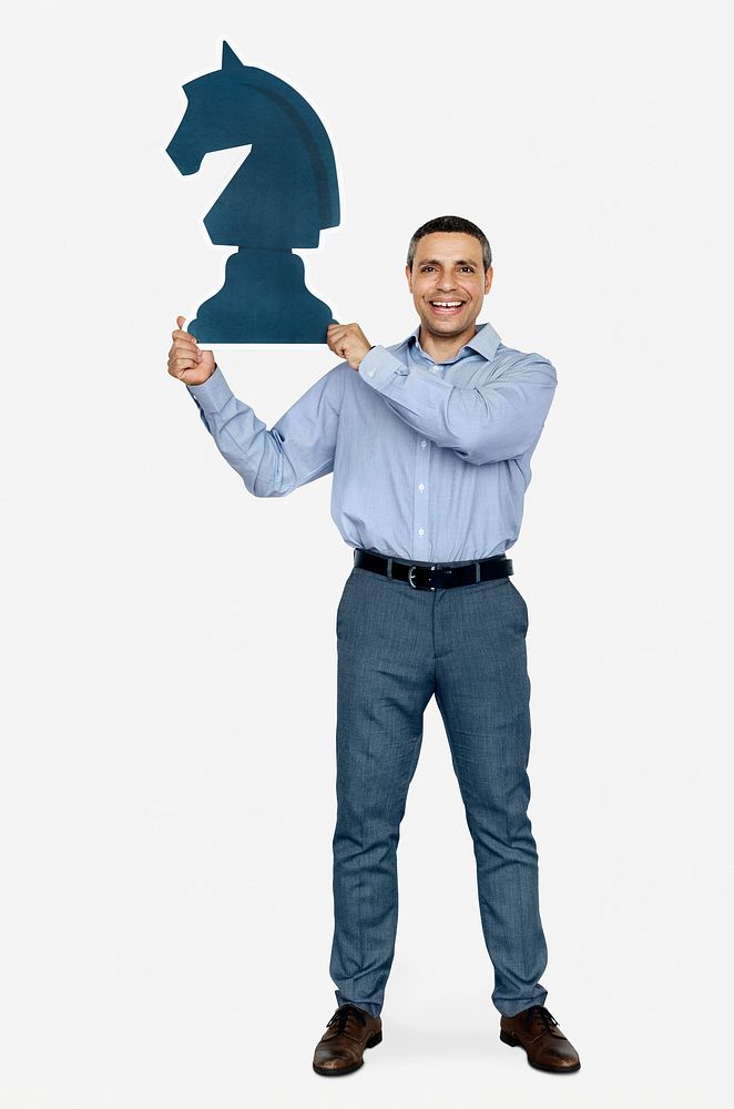 Businessman holding a chess piece